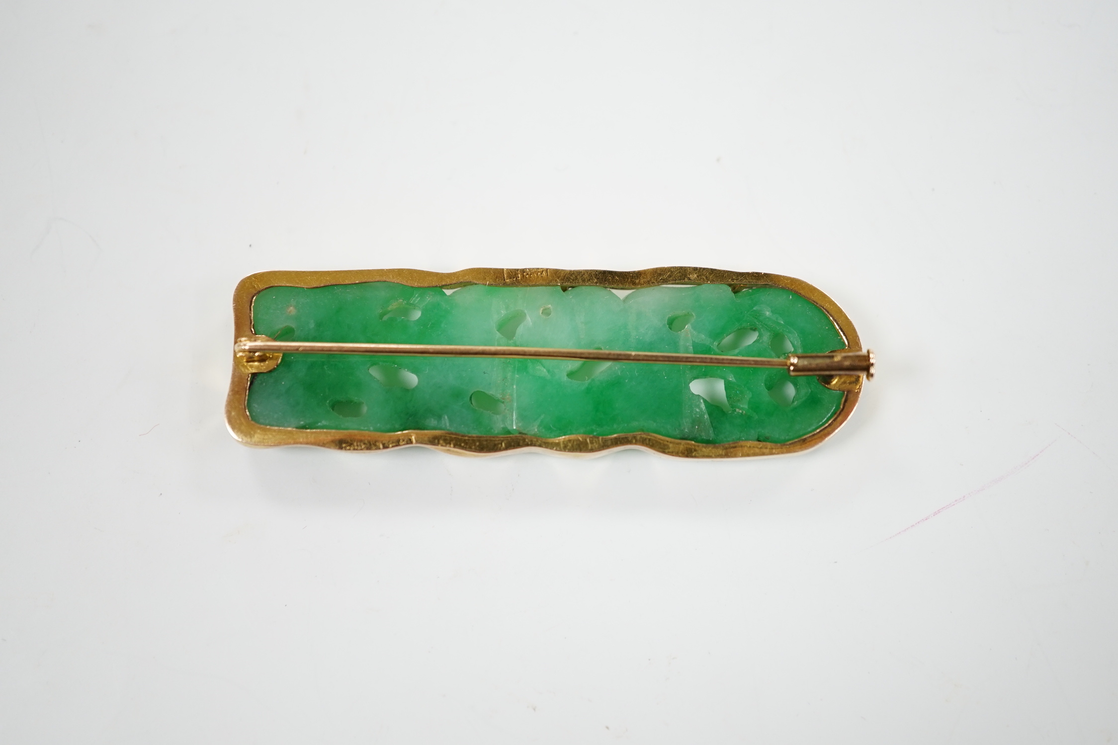 A Chinese 14k yellow metal and carved jade set rounded rectangular brooch, 63mm